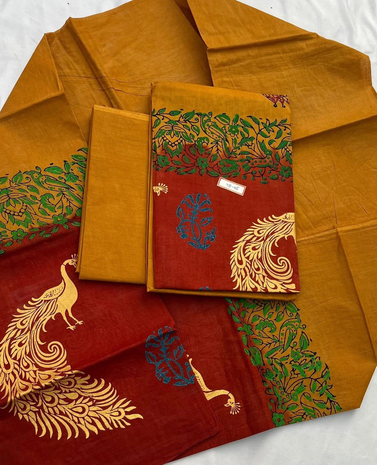 Orange Brown Colour cotton dress material featuring a beautifully crafted peacock design.