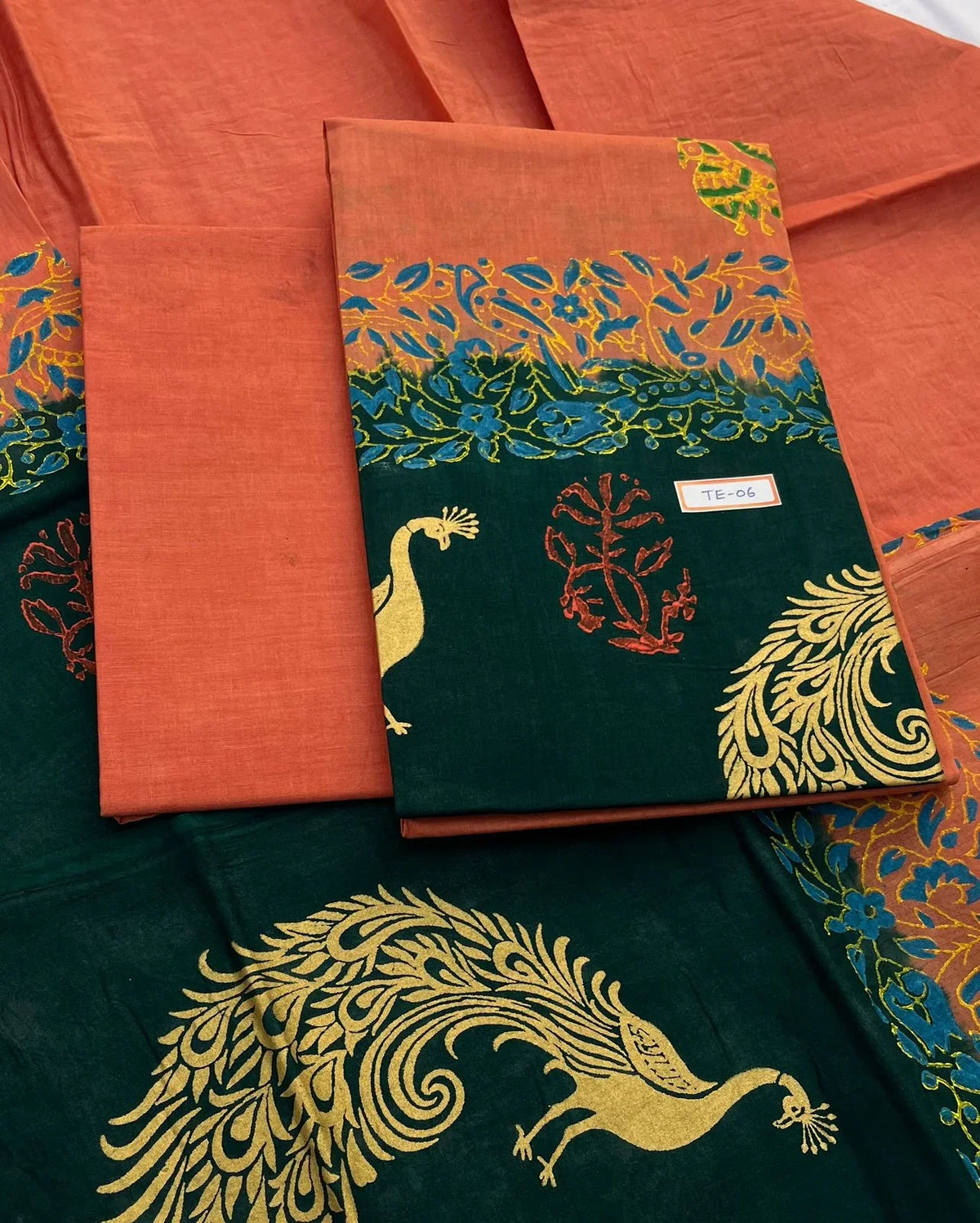 Sunrise Orange Colour cotton dress material featuring a beautifully crafted peacock design.