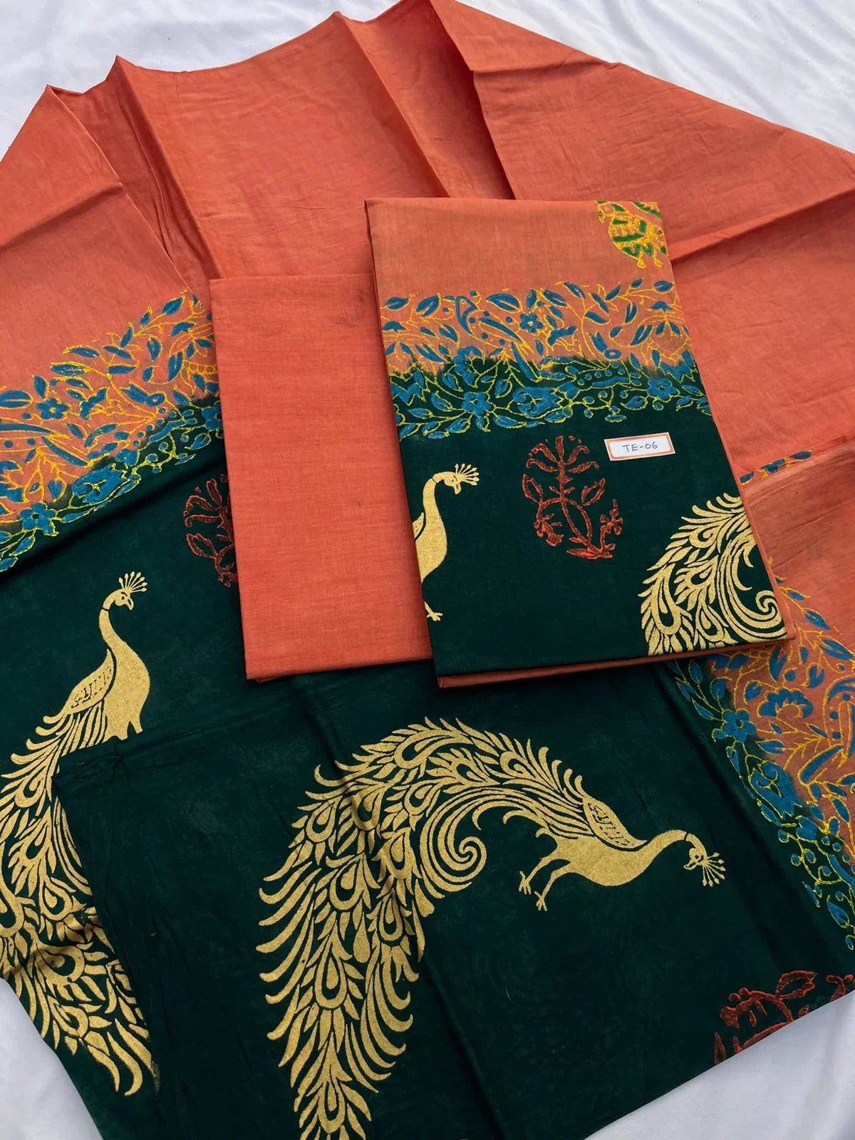 Sunrise Orange Colour cotton dress material featuring a beautifully crafted peacock design.