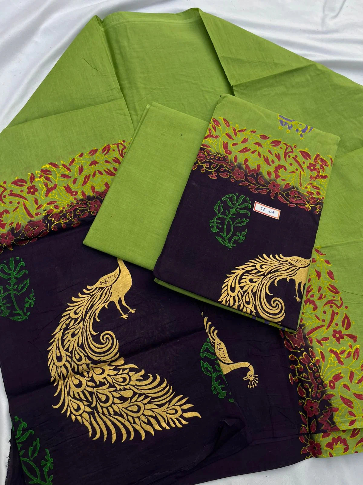 Green Colour cotton dress material featuring a beautifully crafted peacock design.