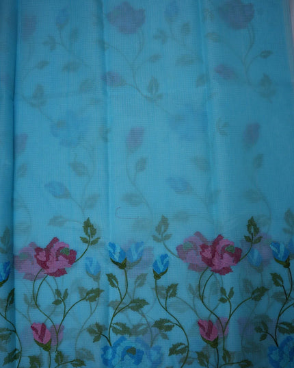 Bhavana Handlooms aqua blue silk Kota saree featuring intricate floral vine embroidery and a woven border.