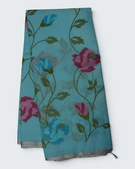 Bhavana Handlooms aqua blue silk Kota saree featuring all-over floral vine embroidery and an elegant woven border.