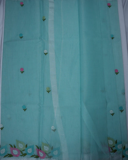 Bhavana Handlooms aqua blue silk Kota saree featuring delicate multicolor floral embroidery and a woven border.