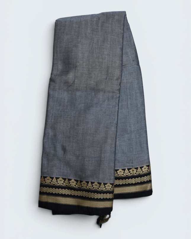 Bhavana Handlooms ash grey mercerized cotton saree with traditional woven black and gold border. Lightweight and soft finish.