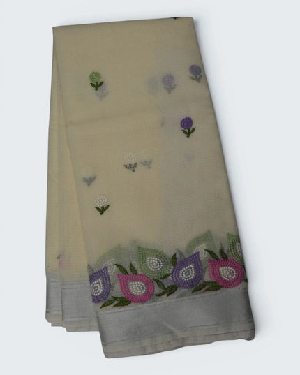 Bhavana Handlooms beige silk Kota saree featuring delicate floral embroidery motifs and a multicolor designer border.