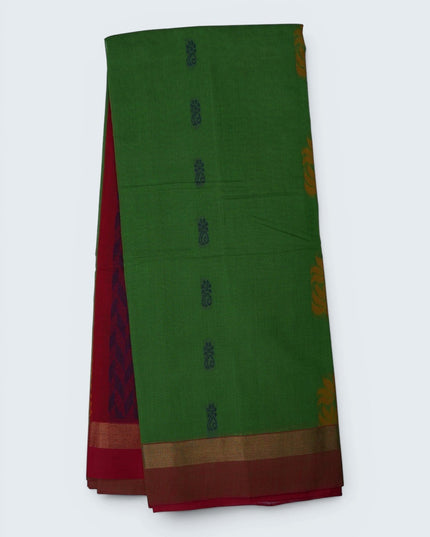 Bhavana Handlooms parrot green Coimbatore handloom saree with floral butta motifs and a contrast rani pink zari border
