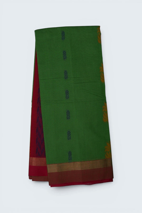 Bhavana Handlooms parrot green Coimbatore handloom saree with floral butta motifs and a contrast rani pink zari border