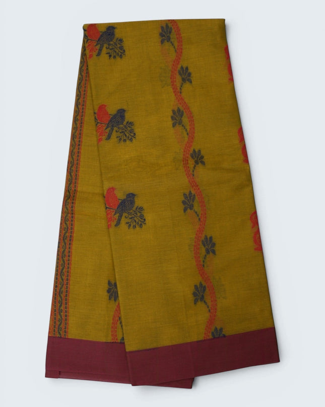 Bhavana Handlooms mustard yellow Coimbatore handloom saree featuring traditional bird motifs and a maroon woven border.