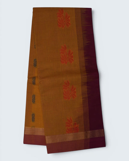 Bhavana Handlooms mustard yellow Coimbatore handloom saree with floral butta motifs and a contrast rani pink zari border