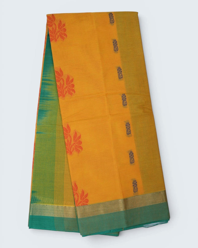 Bhavana Handlooms mustard yellow Coimbatore handloom saree featuring traditional floral butta motifs and green border.