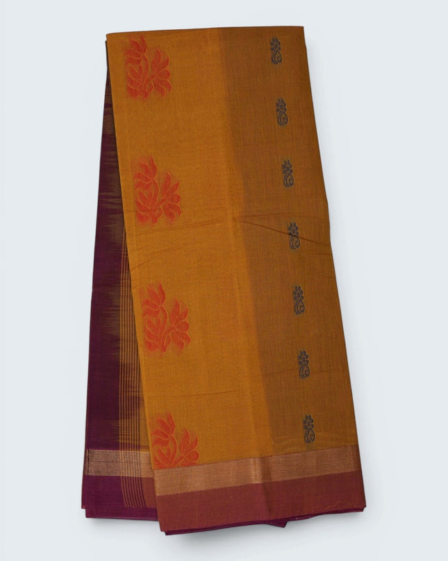 Bhavana Handlooms mustard yellow Coimbatore handloom saree featuring traditional floral butta motifs and a maroon border.