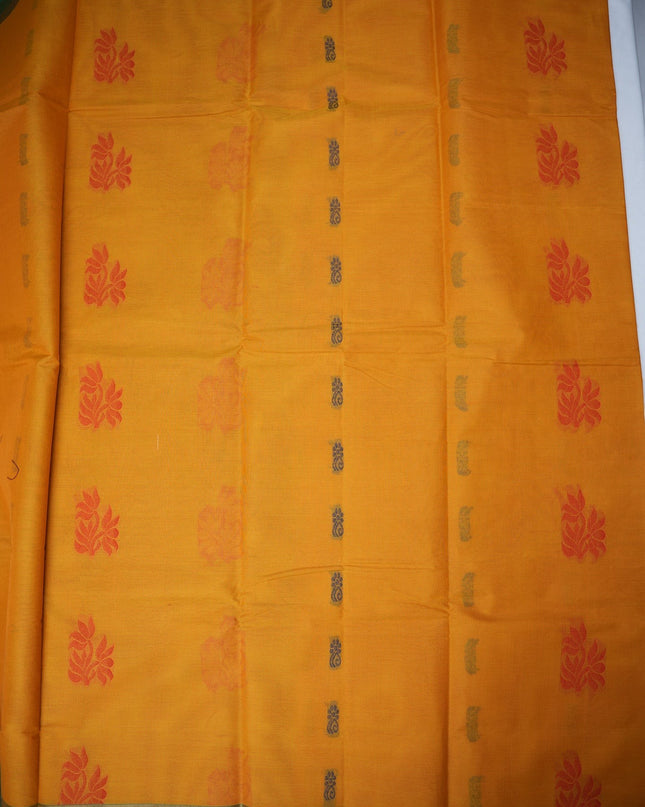 Bhavana Handlooms mustard yellow Coimbatore handloom saree featuring traditional red floral butta motifs and green borders.