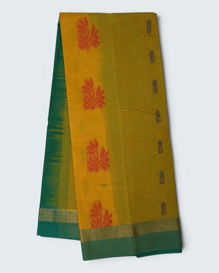 Bhavana Handlooms mustard yellow Coimbatore handloom saree with red floral motifs and a contrast aqua blue border.