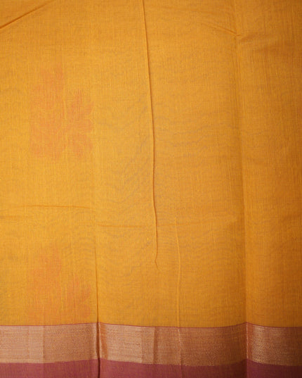 Bhavana Handlooms mustard yellow Coimbatore handloom saree with traditional floral butta motifs and a contrast border.