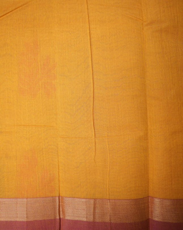Bhavana Handlooms mustard yellow Coimbatore handloom saree with traditional floral butta motifs and a contrast border.