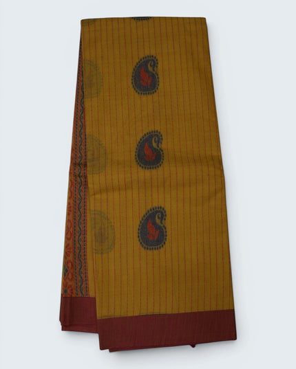 Bhavana Handlooms mustard yellow Coimbatore handloom saree with traditional paisley motifs and a maroon woven border.