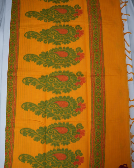 Bhavana Handlooms mustard yellow Coimbatore handloom saree featuring green paisley motifs and a maroon woven border.