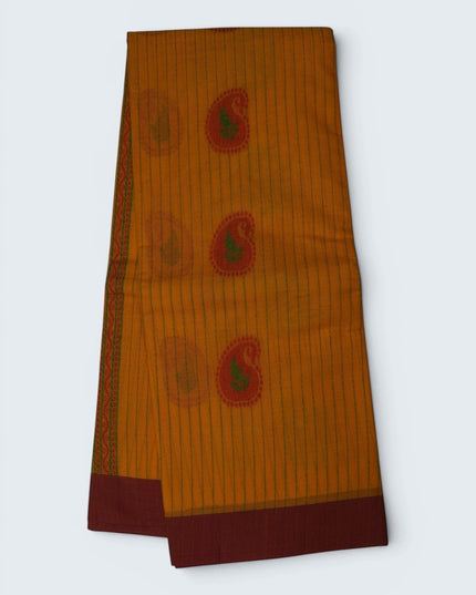 Bhavana Handlooms mustard yellow Coimbatore handloom saree with green paisley motifs and a contrast maroon border.
