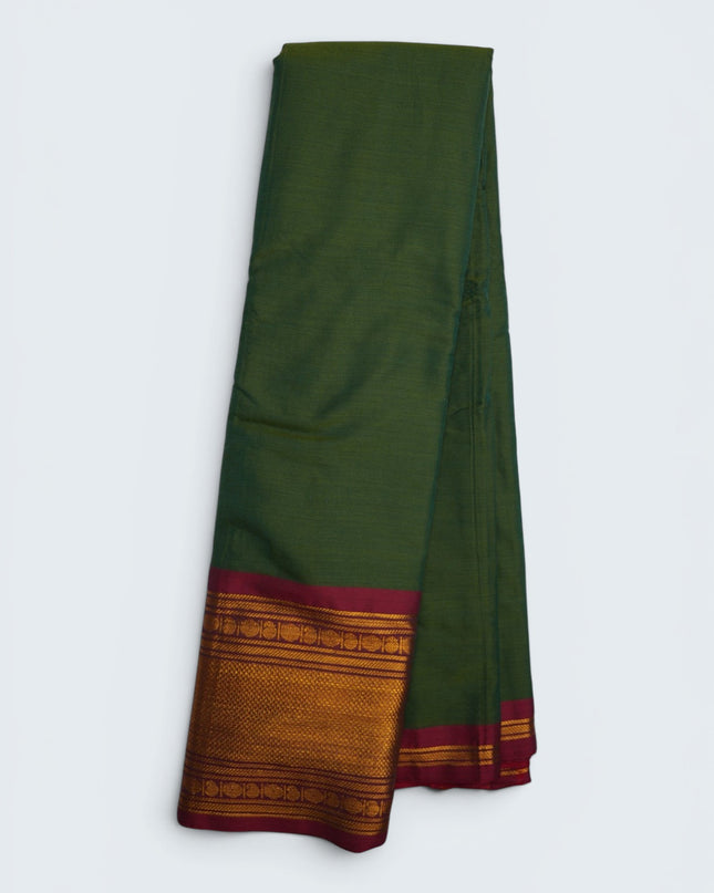 Bhavana Handlooms olive green mercerized cotton saree with rich zari border and maroon trim. Lightweight, soft finish.