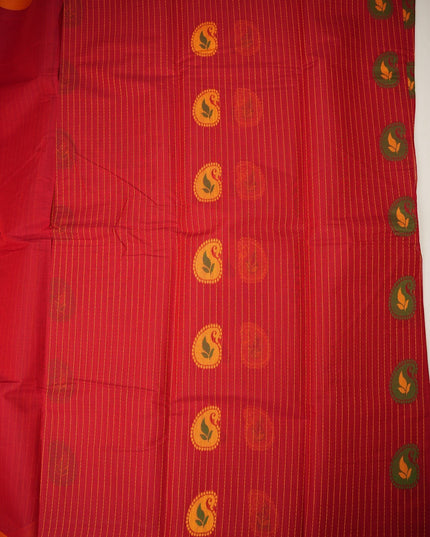 Bhavana Handlooms tomato red handloom saree with traditional paisley motifs and a contrast peach orange woven border.