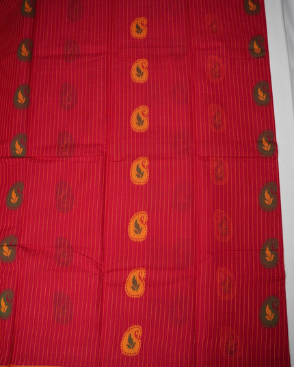 Bhavana Handlooms tomato red handloom saree with vertical stripes, traditional paisley motifs, and green woven border.