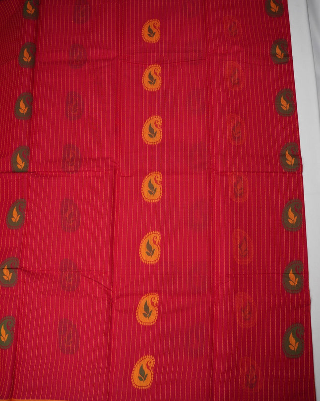 Bhavana Handlooms tomato red handloom saree with vertical stripes, traditional paisley motifs, and green woven border.