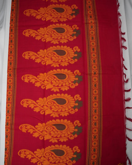 Bhavana Handlooms tomato red Coimbatore handloom saree featuring large orange paisley motifs and a green woven border.