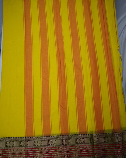 Bhavana Handlooms bright turmeric yellow mercerized cotton saree with orange stripes and traditional peacock zari border. Lightweight and soft finish.