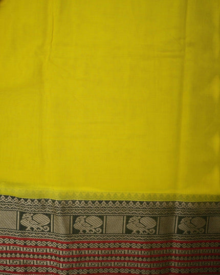 Bhavana Handlooms bright turmeric yellow mercerized cotton saree with traditional peacock zari border and red trim. Lightweight drape.