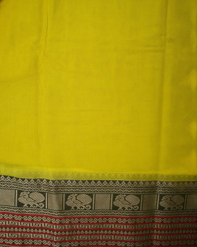 Bhavana Handlooms bright turmeric yellow mercerized cotton saree with traditional peacock zari border and red trim. Lightweight drape.