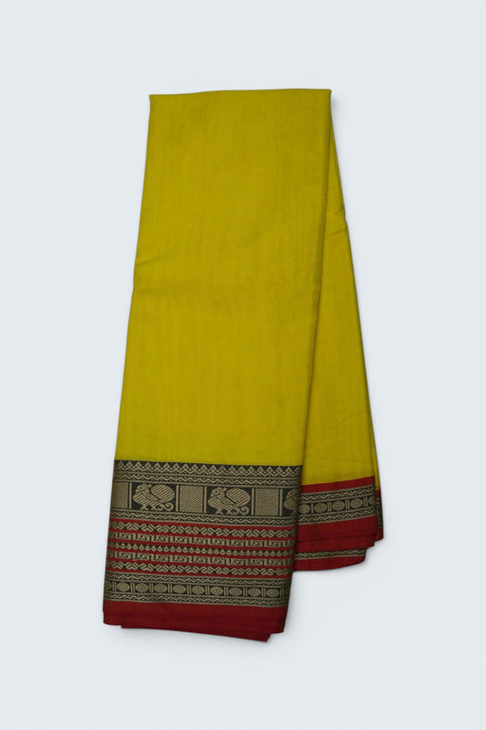 Bhavana Handlooms bright turmeric yellow mercerized cotton saree with traditional peacock zari border and red hem. Lightweight drape.